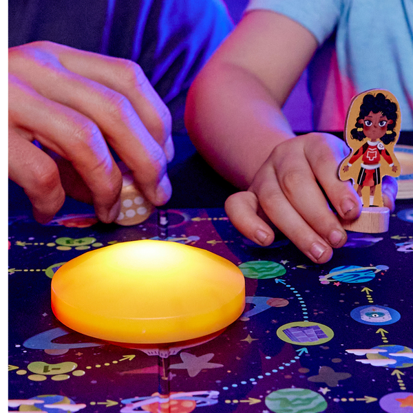 Close-up of Star Seekers game components: figurines, cards, LED sun – Kenya