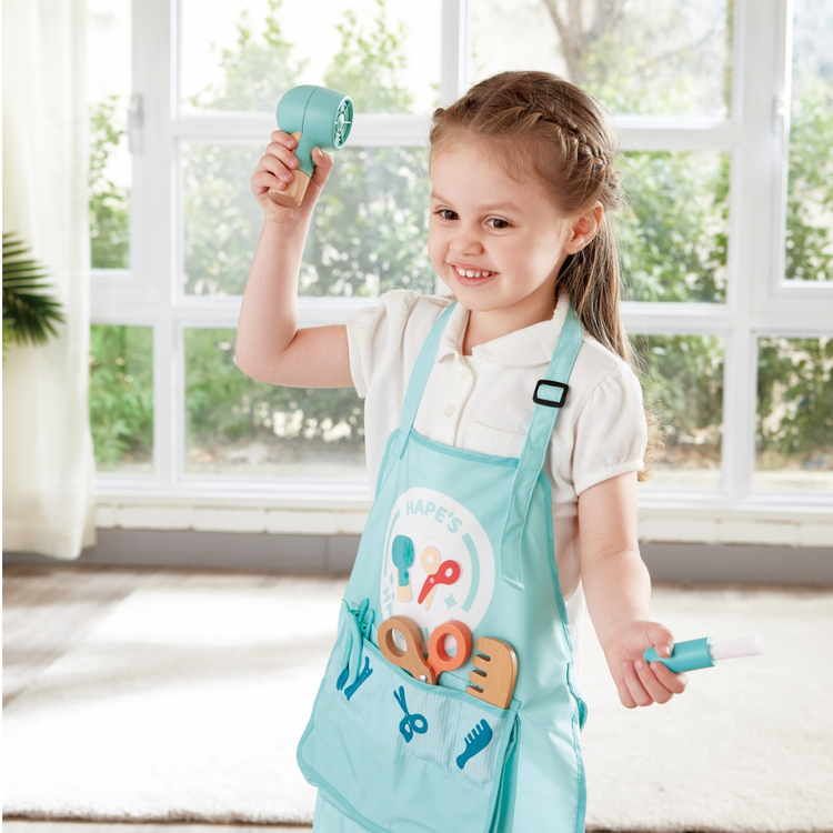 Close-up of high-quality wooden salon tools from the Hape Hair Salon Set — smooth edges and colorful designs safe for kids in Kenyan homes and schools.