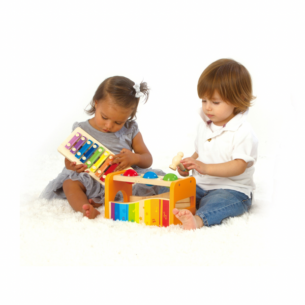 Toddler playing with Hape Pound and Tap Bench – educational wooden toy that builds coordination and rhythm, sold by Cheza Plus Kenya.