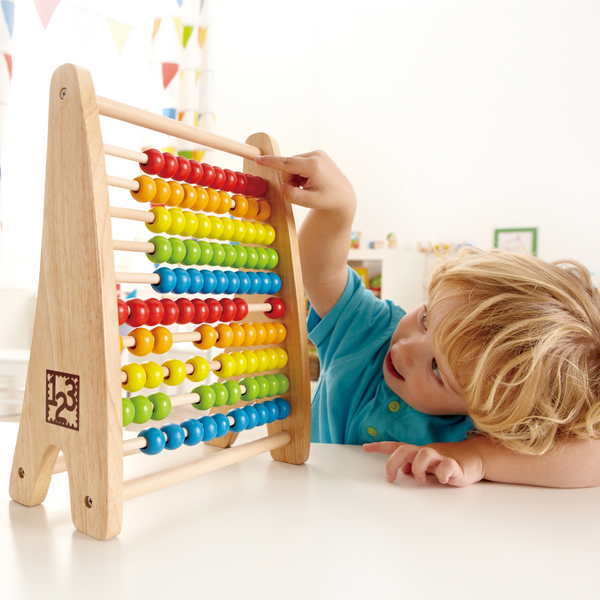 Child playing with wooden abacus – counting and learning – Kenya
