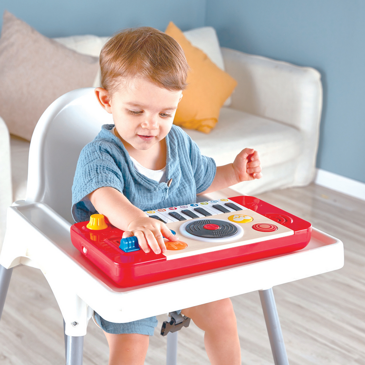 Toddler playing with Hape DJ Mix & Spin Musical Toy – fun interactive DJ set that helps develop rhythm and coordination, sold by Cheza Plus Kenya.
