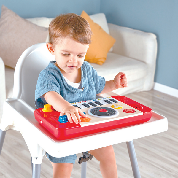 Toddler playing with Hape DJ Mix & Spin Musical Toy – fun interactive DJ set that helps develop rhythm and coordination, sold by Cheza Plus Kenya.