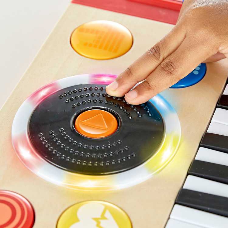 Close-up of Hape DJ Mix & Spin Musical Toy showing colorful keys, buttons, and DJ sound controls – educational wooden music toy from Cheza Plus Nairobi.