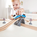 Passenger Train Set Hape, Young child playing with Hape wooden train set on the floor – hands-on learning toy in Kenya