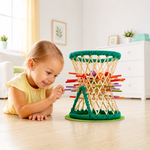 Child playing with the Hape Pallina Original bamboo dexterity game, developing concentration, fine motor skills and hand-eye coordination.