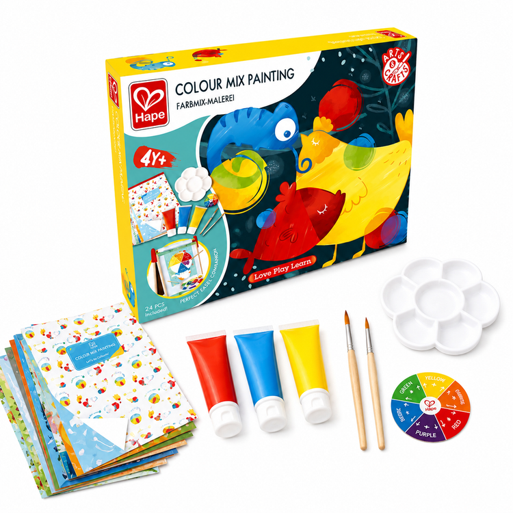 Hape Colour Mix Painting Set with the product box, activity booklets, red, blue and yellow paint tubes, paintbrushes, paint palette and colour wheel displayed on a warm, sunlit background. Educational art kit for children aged 4+.