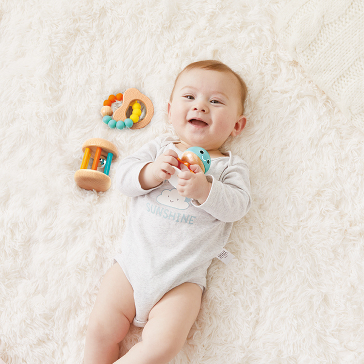 Baby playing with Hape sensory gift set