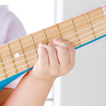 Close-up of Hape Blue Lagoon Guitar showing wooden body and nylon strings – safe musical toy for kids from Cheza Plus Nairobi.