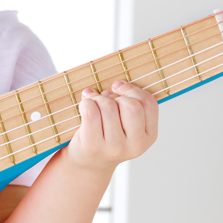 Close-up of Hape Blue Lagoon Guitar showing wooden body and nylon strings – safe musical toy for kids from Cheza Plus Nairobi.