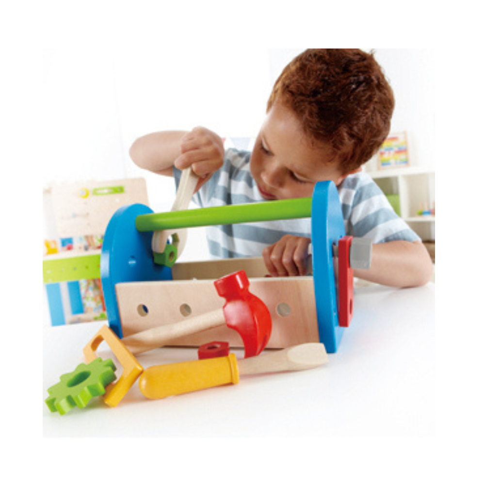 Kid playing with wooden tool box for kids available at cheza plus în Kenya 
