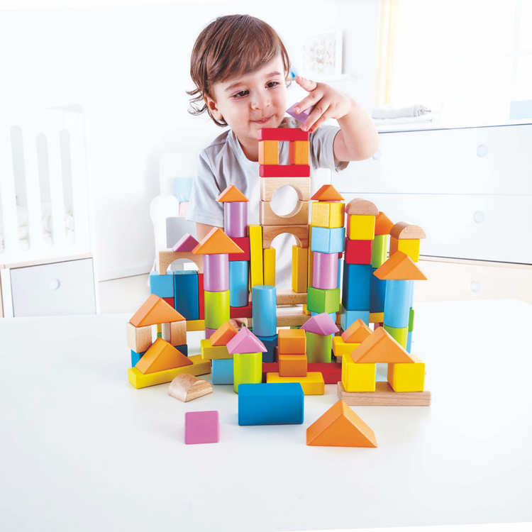 Child building colourful wood blocks – Hape E8247 set – Kenya
